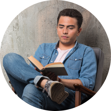 Two men standing beside each other--one holding a book, the other holding a Captain America sheild.